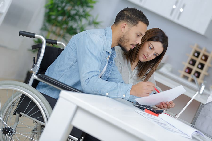 Disability Insurance - Couple at Home Reading Information