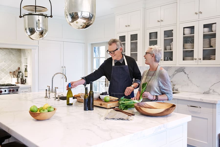 High Net Worth Insurance - Mature Couple Cooking in Modern Kitchen of Their Luxury Home