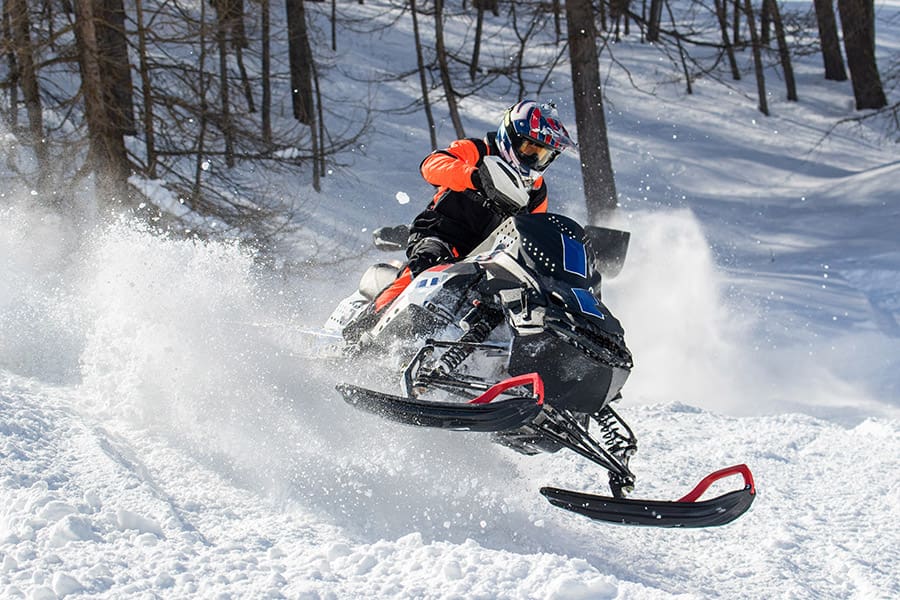 Snowmobile Insurance - Snowmobile and Rider in Action in the Snow