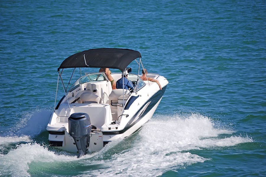 Watercraft Insurance - Outboard Motorboat with Blue Canvas Canopy
