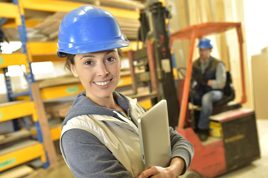 Workers’ Compensation Insurance - Smiling Woman Working in Warehouse