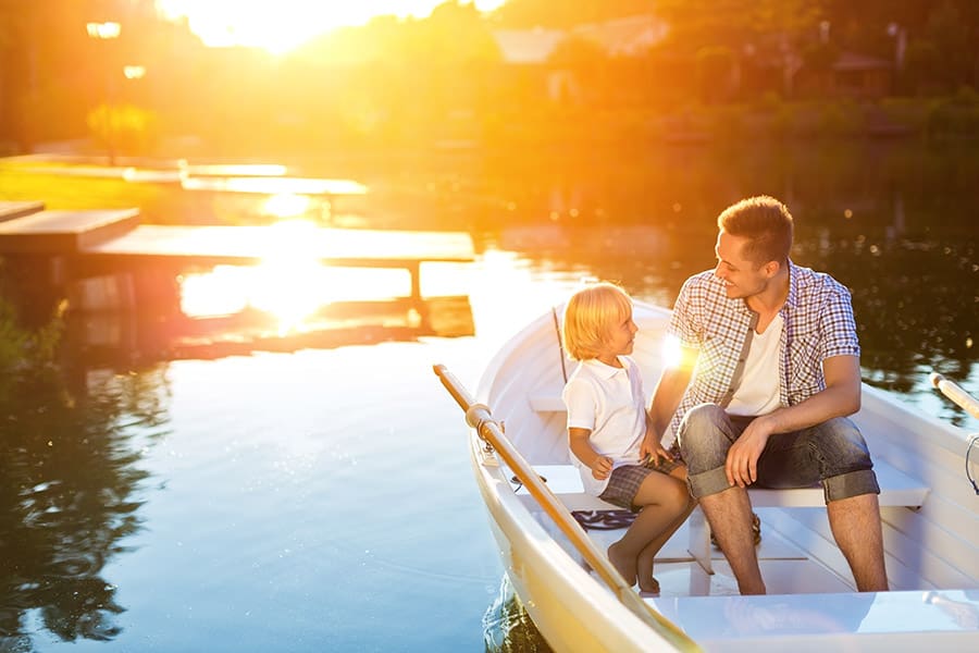 Life-Insurance-Agency-New Hampshire-Father-and-Sun-Riding-in-a-Boat-on-a-Lake-at-Sunset