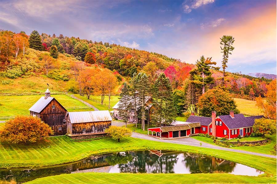Insuring Vermont - Beautiful Vermont Farm House with Brown Barn Infront of a Lake in the Fall with a Rainbow in the Sky