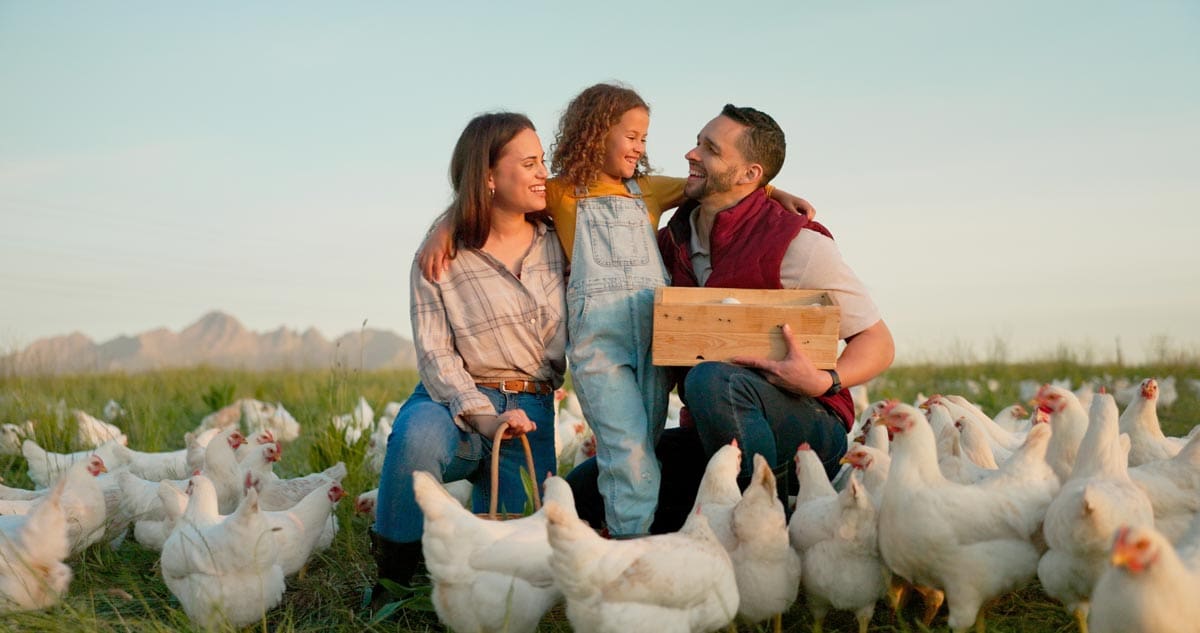 Mother, father with child on chicken farm