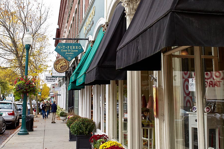 Business Owner’s Insurance in Vermont - Businesses and Shops Lined Down a Main Street with People Walking Down the Sidewalk in Vermont on a Nice Day