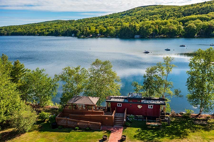 Sunapee, NH - Aerial View of a Waterfront Property Surrounded by Green Foliage in Sunapee New Hampshire
