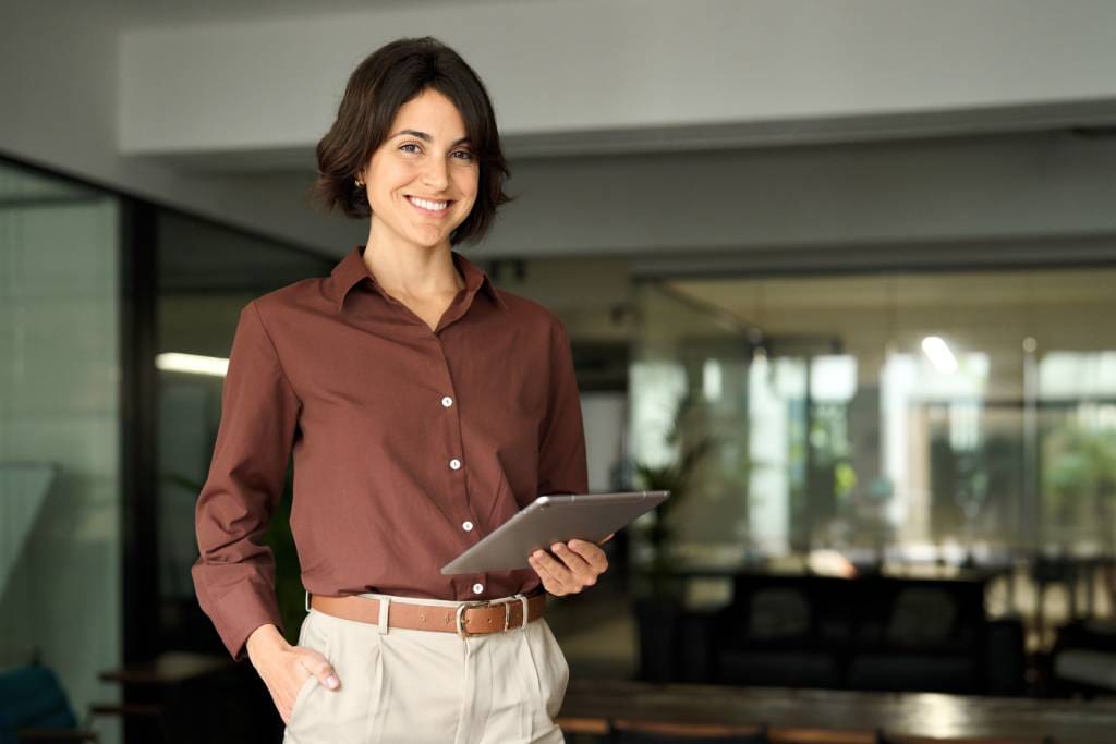 Portrait of young Hispanic professional business woman standing in office.