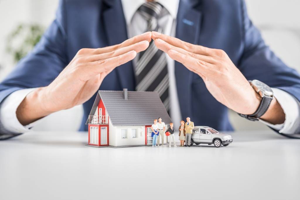 Insurance bundle with figurines for house, car and family